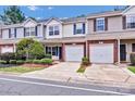 Well-maintained townhouses featuring attached garages, neatly manicured front yards and paved driveways at 804 Eddy Dr, Fort Mill, SC 29715