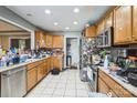 Functional kitchen with light wood cabinets and stainless steel appliances, needs decluttering at 9575 Old Concord Rd, China Grove, NC 28023