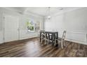 Well-lit dining area with hardwood floors, chair rail, and a window offering natural light at 117 Cramerton Mills Pkwy, Cramerton, NC 28032