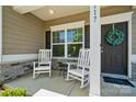 Inviting front porch featuring rocking chairs and stone accents at 117 Cramerton Mills Pkwy, Cramerton, NC 28032