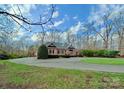 Beautiful brick house set on an expansive lot with mature trees and a circular driveway at 1419 Ridge St, Albemarle, NC 28001