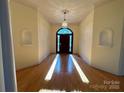 Elegant foyer featuring hardwood floors, classic lighting, and decorative niches at 1419 Ridge St, Albemarle, NC 28001