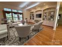 Bright living room featuring hardwood floors, built-in shelving, and large windows with natural light at 1419 Ridge St, Albemarle, NC 28001