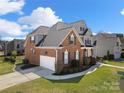 Beautifully landscaped home with a brick and siding exterior, showcasing a well-maintained lawn and inviting curb appeal at 1736 Townsend Ln, Rock Hill, SC 29730