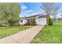 Charming home with an attached garage and lengthy driveway, creating an inviting curb appeal at 301 N 4Th Ave, Maiden, NC 28650