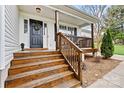 Inviting front porch with wooden stairs and railings, creating a warm welcome at 301 N 4Th Ave, Maiden, NC 28650