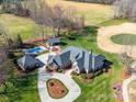 Expansive estate with a luxurious pool, golf area, meticulously landscaped grounds, and circular driveway at 810 Lake Wright Rd, China Grove, NC 28023