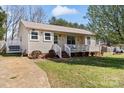 Quaint single-story home with a welcoming front porch and well-maintained lawn at 111 Cedar Dr, Salisbury, NC 28147