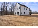 A generous backyard offering a blank canvas, with a view of the home's rear windows and siding at 113 Homewood Ln, Statesville, NC 28625