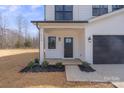 Welcoming front porch with well-manicured landscaping, enhancing curb appeal, and includes a two-car garage at 113 Homewood Ln, Statesville, NC 28625