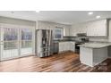 Bright kitchen featuring stainless steel appliances, white cabinets, granite countertops, and access to the deck at 118 Alfara Ln, Troutman, NC 28166