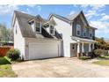 View of the home highlighting the attached two-car garage and complementary siding at 134 Cline St, Concord, NC 28027