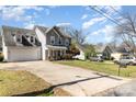 View of a two-story home featuring a two-car garage and an expansive driveway at 134 Cline St, Concord, NC 28027