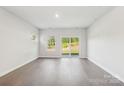 An airy living room with hardwood floors and sliding glass doors that provide ample natural light at 138 Satchel Ct, Mooresville, NC 28115