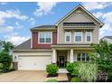Inviting two-story home boasting a two-car garage, well-kept lawn, and a cozy front porch at 16839 Cozy Cove Rd, Charlotte, NC 28278