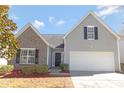 A welcoming home showcasing a blend of brick and siding, complemented by a two-car garage and tasteful landscaping at 1911 Kingstree Dr, Monroe, NC 28112