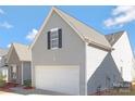 A two-car garage featuring exterior siding, a window, and an attached home, providing convenience and functionality at 1911 Kingstree Dr, Monroe, NC 28112