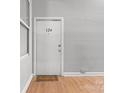 Apartment entry with welcome mat and door number, with neutral wall color at 201 Hoskins S Rd # 124, Charlotte, NC 28208