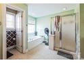 Bright bathroom with a soaking tub and a separate glass door shower at 3230 Creek Bend Ct, Sherrills Ford, NC 28673