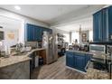 A rustic-style kitchen with granite countertops and modern stainless steel appliances at 3230 Creek Bend Ct, Sherrills Ford, NC 28673