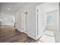 Bright hallway with hardwood floors and white walls and trim leading to multiple rooms at 4011 Vista Pine Dr, Charlotte, NC 28215