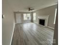 Bright living room with a fireplace, ceiling fan, and wood-look floors at 4904 Cornelia Dr, Charlotte, NC 28269