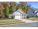 Attractive home with two-car garage and a stone accented entryway is surrounded by mature trees at 541 Settlers Grove Ln # 49, Salisbury, NC 28146