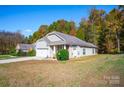 Well-maintained home featuring neutral siding, an attached garage, and a neatly kept lawn at 541 Settlers Grove Ln # 49, Salisbury, NC 28146