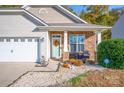 Welcoming front porch with seating and autumn wreath, accented by decorative stonework at 541 Settlers Grove Ln # 49, Salisbury, NC 28146