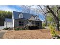 Charming home featuring a stone facade, black shutters, and a metal roof at 618 Camp Rotary Rd, Gastonia, NC 28052