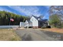 View of the home's side and backyard, featuring a metal roof and white siding at 618 Camp Rotary Rd, Gastonia, NC 28052