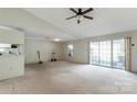 Spacious living room features neutral carpet, access to the kitchen, a ceiling fan and sliding glass doors at 657 Heathridge Rd, Rock Hill, SC 29732