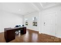 Bright office space with wood floors, a desk, and natural light from two windows at 7314 Rupell Dr, Charlotte, NC 28273