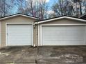 Spacious two-car garage featuring white doors and beige siding, perfect for vehicle storage at 1138 Stateline Rd # 1, Lake Wylie, SC 29710