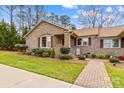 Lovely brick home with manicured lawn, brick walkway, and neatly trimmed shrubs at 1202 Ravenwood Ct, Salisbury, NC 28147