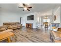 Open-concept living area with hardwood floors, large TV, and decorative shelving at 1370 Martin Rd, Hickory Grove, SC 29717