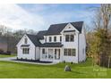 Charming two-story modern farmhouse with black frame windows and a cozy front porch at 1465 Highcrest Way, Rock Hill, SC 29730