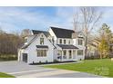 Elegant home featuring a modern garage, well-manicured lawn, black windows and a welcoming front porch at 1465 Highcrest Way, Rock Hill, SC 29730