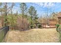 Fenced backyard featuring a wooden deck and wooded view at 147 Amber Woods Dr, Tega Cay, SC 29708