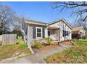 Cozy single-story home with light siding, dark shutters, and well-maintained landscaping at 1509 Harrill St, Charlotte, NC 28205