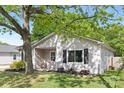 Inviting home with black shutters, a well-kept lawn, and a mature shade tree providing curb appeal at 1509 Harrill St, Charlotte, NC 28205