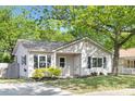 Beautiful single-story home with updated siding, black shutters, and a verdant, landscaped front yard at 1509 Harrill St, Charlotte, NC 28205