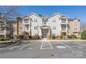 Well-maintained apartment building featuring multiple balconies, visible parking and landscaping at 16312 Redstone Mountain Ln, Charlotte, NC 28277