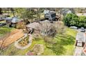 An aerial view of the home, showing a well-kept lawn, mature trees, and detached garage at 1815 W Sugar Creek Rd, Charlotte, NC 28262