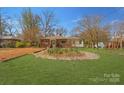 Charming brick home with a metal roof, a well-manicured front yard, and mature trees at 1815 W Sugar Creek Rd, Charlotte, NC 28262