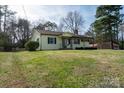 Single-story home with a well-manicured lawn, complimented by mature trees at 1909 Stokes Ferry Rd, Salisbury, NC 28146