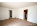 Spacious living room featuring carpeted floors and an open layout, leading to other rooms at 2825 Bancroft St # C, Charlotte, NC 28206