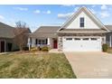 Charming single-Gathering home with stone accents, a red door, and an attached two-car garage at 420 Spring Arbor Ave # 80, Salisbury, NC 28146