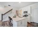 Contemporary kitchen with an island, modern appliances, and a view of the staircase at 4235 Black Ct # 197, Harrisburg, NC 28075