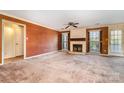 Cozy living room with a fireplace, large windows, and neutral-toned walls for versatile decor at 4309 Woodglen Ln, Charlotte, NC 28226